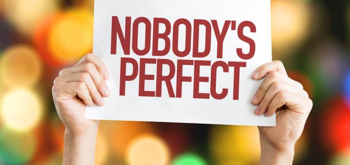 hands holding up sign that says nobody's perfect