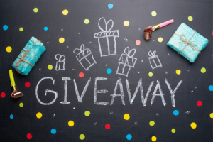 word giveaway written in chalk surrounded by wrapped gifts and confetti to celebrate running giveaways to grow your social media audience