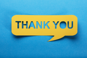 blue background with yellow paper speech bubble and the words "thank you" cut out of the paper speech bubble in the center